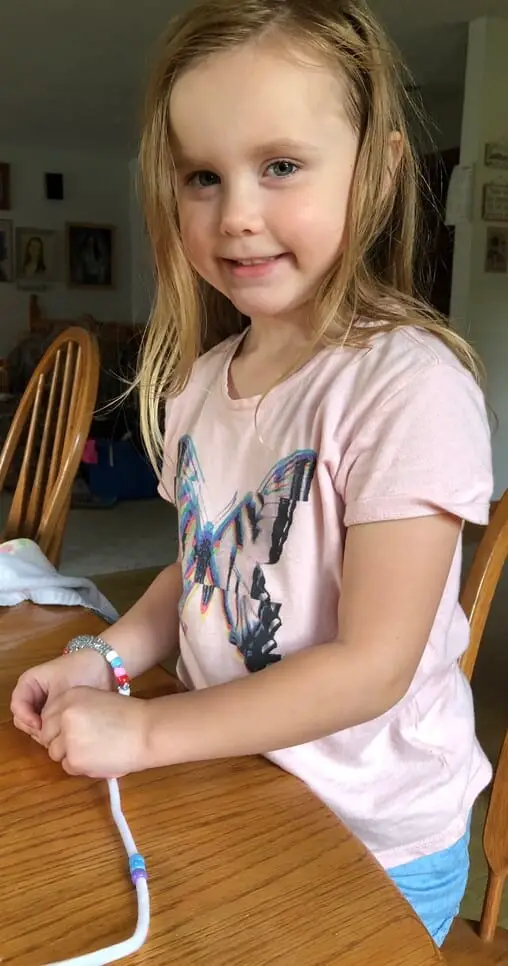 Quinn making bracelets