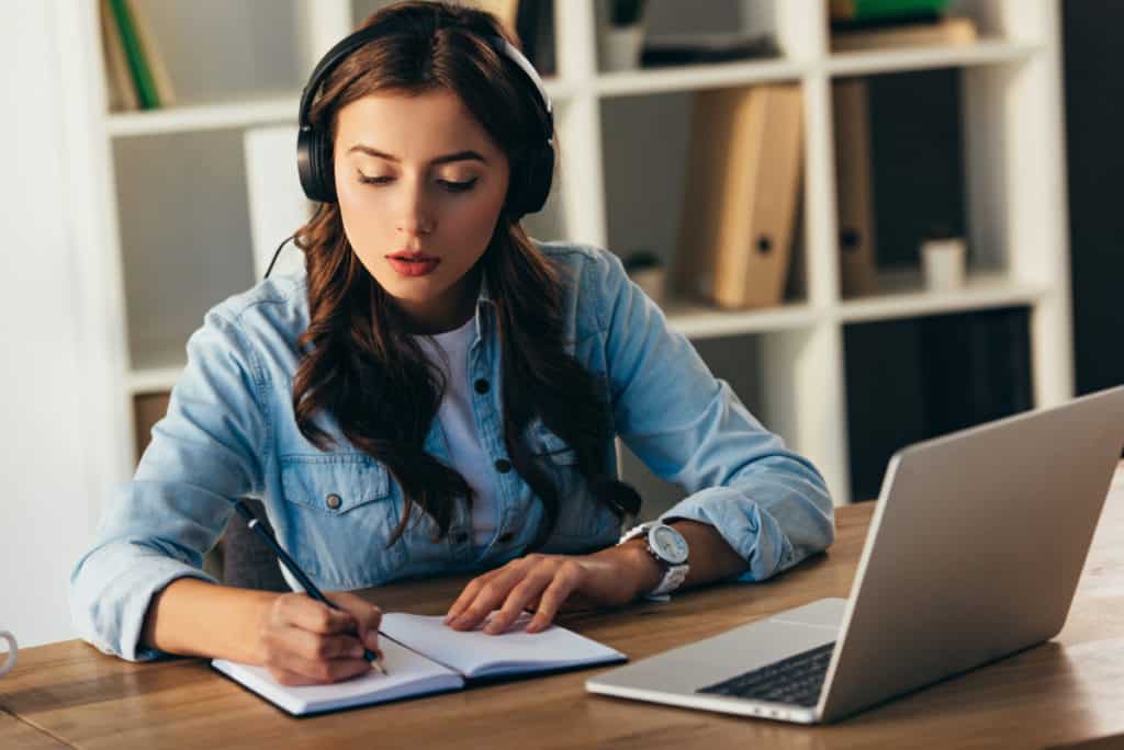 Woman studying with headphones on