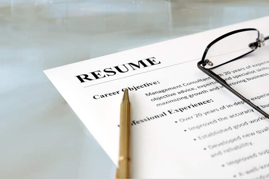 picture of a resume with a pencil and glasses on it