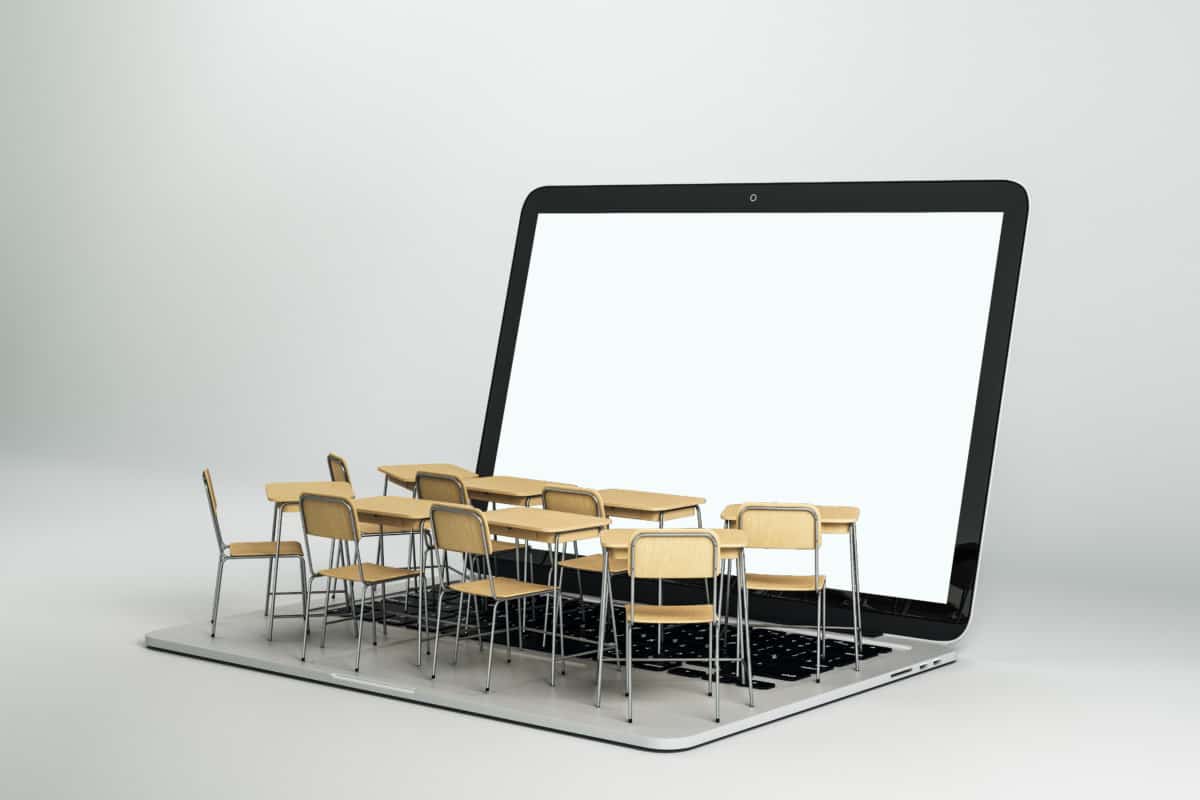 Empty white laptop with abstract tiny classroom desktops on grey background. Online education and webinar concept. Mock up, 3D Rendering
