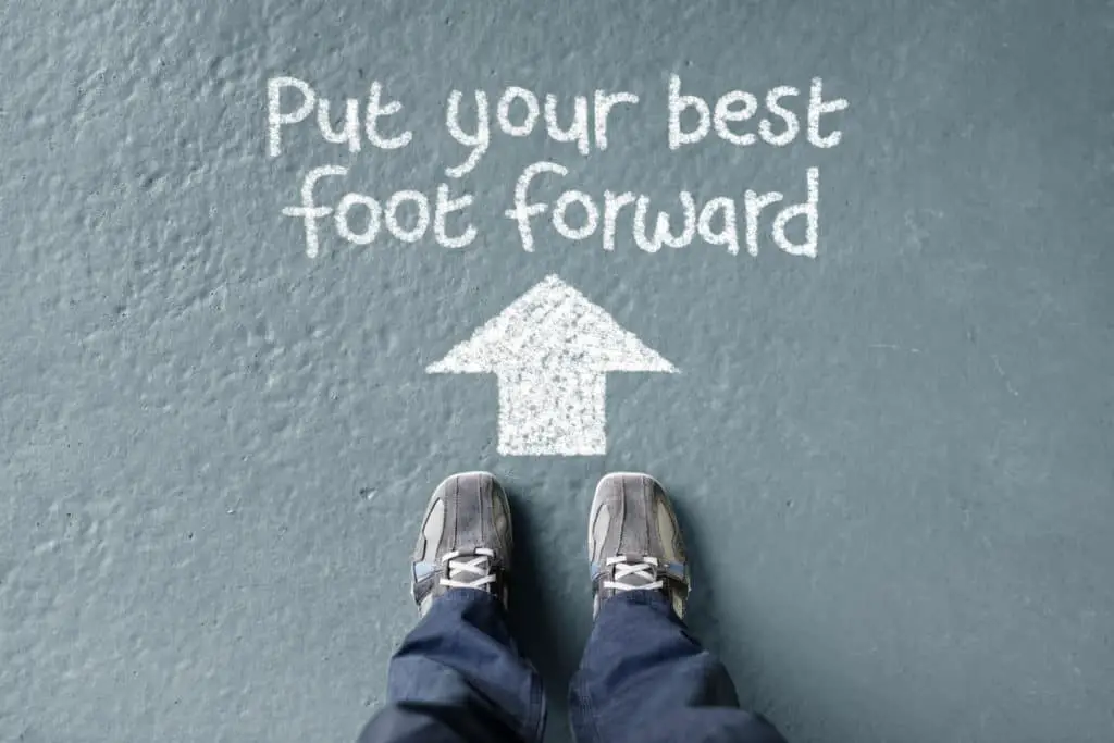 Put your best foot forward man standing with direction arrow to move forward